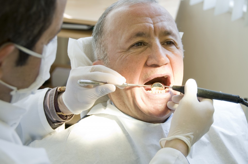 man receiving check up at dentist