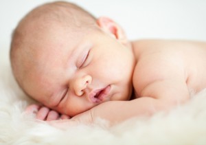 newborn baby girl sleeping on her stomach