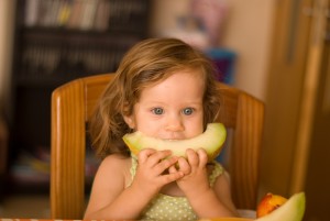 toddler eating melon